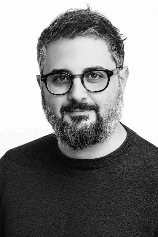 Manuel Diamanti, professional destination wedding photographer from Umbria Italy, holding camera